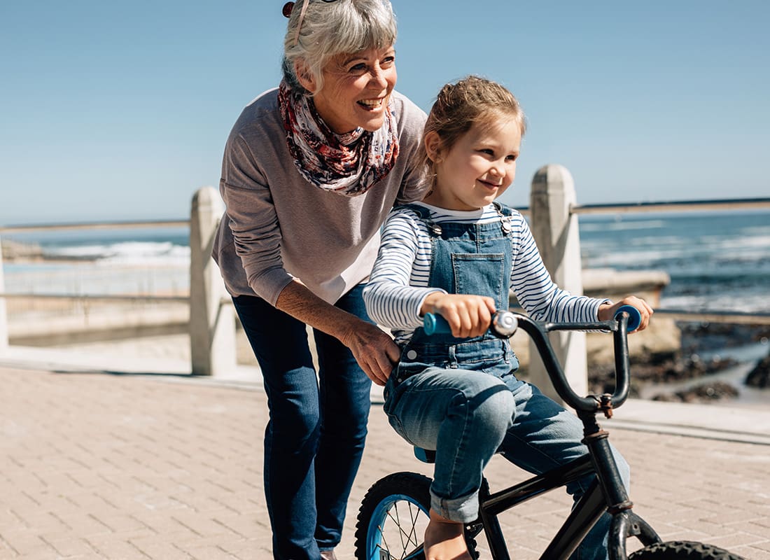 Employee Benefits - Grandmother Teaching Her Granddaughter to Ride a Bike
